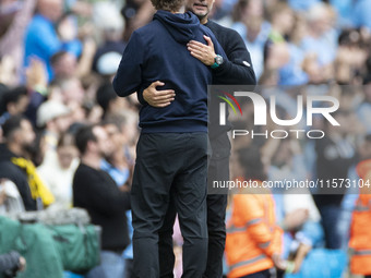 Manchester City F.C. manager Pep Guardiola and Brentford F.C. manager Thomas Franks shake hands at full time during the Premier League match...