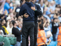 Manchester City F.C. manager Pep Guardiola and Brentford F.C. manager Thomas Franks shake hands at full time during the Premier League match...