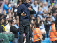 Manchester City F.C. manager Pep Guardiola and Brentford F.C. manager Thomas Franks shake hands at full time during the Premier League match...