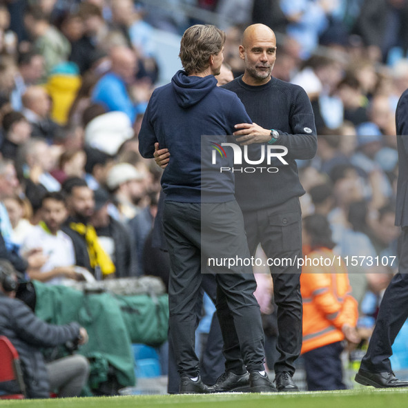 Manchester City F.C. manager Pep Guardiola and Brentford F.C. manager Thomas Franks shake hands at full time during the Premier League match...