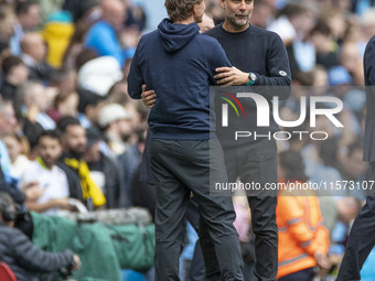 Manchester City F.C. manager Pep Guardiola and Brentford F.C. manager Thomas Franks shake hands at full time during the Premier League match...