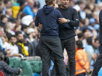 Manchester City F.C. manager Pep Guardiola and Brentford F.C. manager Thomas Franks shake hands at full time during the Premier League match...