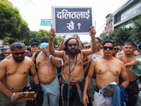 Dalit rights activists hold a shirtless demonstration in Kathmandu, Nepal, on September 14, 2024. The protest, initiated by Khagendra Sunar,...