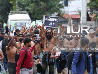 Dalit rights activists hold a shirtless demonstration in Kathmandu, Nepal, on September 14, 2024. The protest, initiated by Khagendra Sunar,...