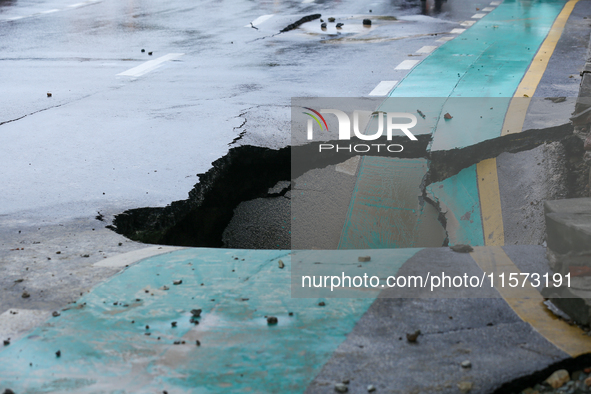 A section of road caves in after a water supply pipe malfunctions in Lalitpur, Nepal, on September 14, 2024. The incidents of roads caving i...