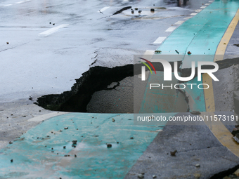 A section of road caves in after a water supply pipe malfunctions in Lalitpur, Nepal, on September 14, 2024. The incidents of roads caving i...