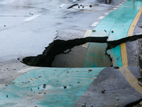 A section of road caves in after a water supply pipe malfunctions in Lalitpur, Nepal, on September 14, 2024. The incidents of roads caving i...