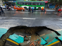 A section of road caves in after a water supply pipe malfunctions in Lalitpur, Nepal, on September 14, 2024. The incidents of roads caving i...