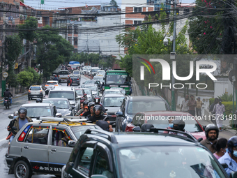 A section of road caves in after a water supply pipe malfunctions in Lalitpur, Nepal, on September 14, 2024. The incidents of roads caving i...