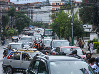 A section of road caves in after a water supply pipe malfunctions in Lalitpur, Nepal, on September 14, 2024. The incidents of roads caving i...