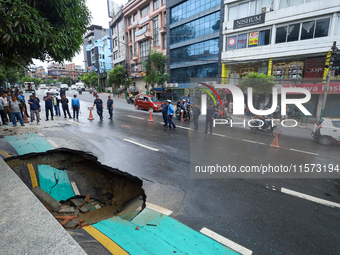 A section of road caves in after a water supply pipe malfunctions in Lalitpur, Nepal, on September 14, 2024. The incidents of roads caving i...