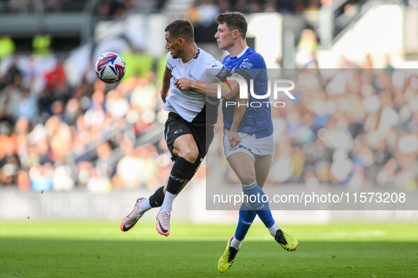 Jerry Yates of Derby County battles with William Fish of Cardiff City during the Sky Bet Championship match between Derby County and Cardiff...