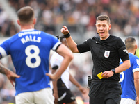 Referee Matthew Donohue shows a yellow card to Joe Ralls of Cardiff City during the Sky Bet Championship match between Derby County and Card...