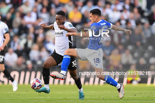 Alex Robertson of Cardiff City battles with Ebou Adams of Derby County during the Sky Bet Championship match between Derby County and Cardif...