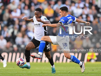 Alex Robertson of Cardiff City battles with Ebou Adams of Derby County during the Sky Bet Championship match between Derby County and Cardif...