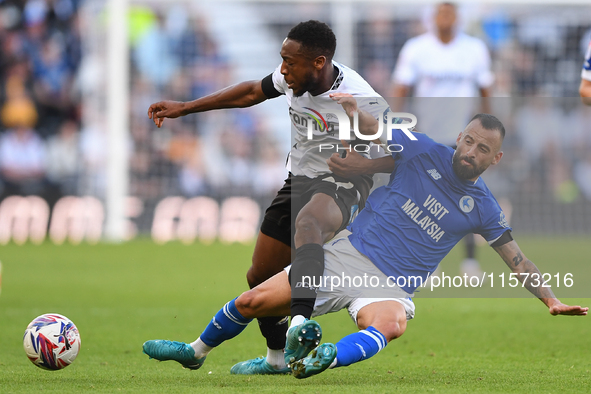 Manolis Siopis of Cardiff City tackles Ebou Adams of Derby County during the Sky Bet Championship match between Derby County and Cardiff Cit...