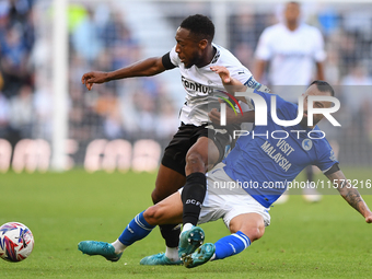 Manolis Siopis of Cardiff City tackles Ebou Adams of Derby County during the Sky Bet Championship match between Derby County and Cardiff Cit...