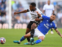 Manolis Siopis of Cardiff City tackles Ebou Adams of Derby County during the Sky Bet Championship match between Derby County and Cardiff Cit...