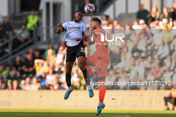 Ebou Adams of Derby County clashes with Jak Alnwick, Cardiff City goalkeeper, during the Sky Bet Championship match between Derby County and...