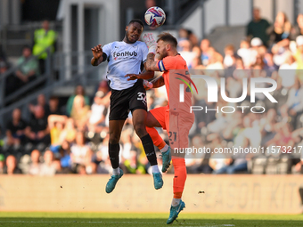 Ebou Adams of Derby County clashes with Jak Alnwick, Cardiff City goalkeeper, during the Sky Bet Championship match between Derby County and...