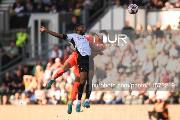 Ebou Adams of Derby County clashes with Jak Alnwick, Cardiff City goalkeeper, during the Sky Bet Championship match between Derby County and...