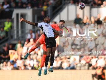 Ebou Adams of Derby County clashes with Jak Alnwick, Cardiff City goalkeeper, during the Sky Bet Championship match between Derby County and...