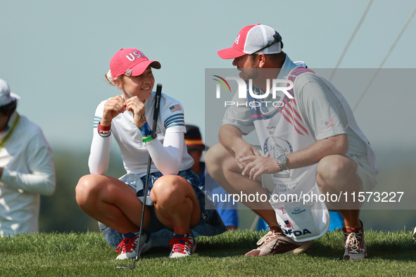 GAINESVILLE, VIRGINIA - SEPTEMBER 14: Nelly Korda of the United States interact with her caddie onthe 17th green during Foursomes Matches on...