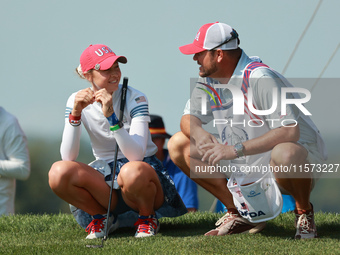 GAINESVILLE, VIRGINIA - SEPTEMBER 14: Nelly Korda of the United States interact with her caddie onthe 17th green during Foursomes Matches on...