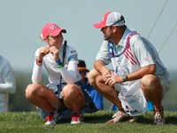 GAINESVILLE, VIRGINIA - SEPTEMBER 14: Nelly Korda of the United States interact with her caddie onthe 17th green during Foursomes Matches on...