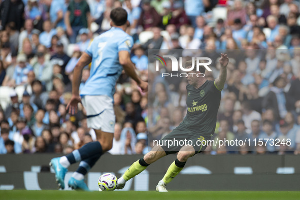 Nathan Collins #22 of Brentford F.C. crosses the ball during the Premier League match between Manchester City and Brentford at the Etihad St...