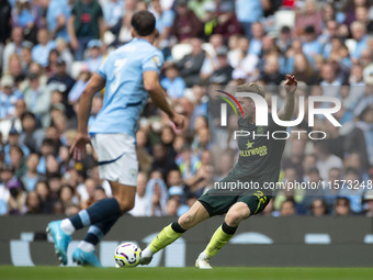 Nathan Collins #22 of Brentford F.C. crosses the ball during the Premier League match between Manchester City and Brentford at the Etihad St...