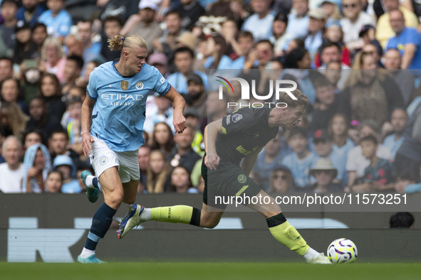 Nathan Collins #22 of Brentford F.C. is tackled by Erling Haaland #9 of Manchester City F.C. during the Premier League match between Manches...