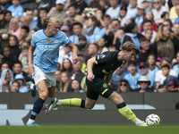 Nathan Collins #22 of Brentford F.C. is tackled by Erling Haaland #9 of Manchester City F.C. during the Premier League match between Manches...