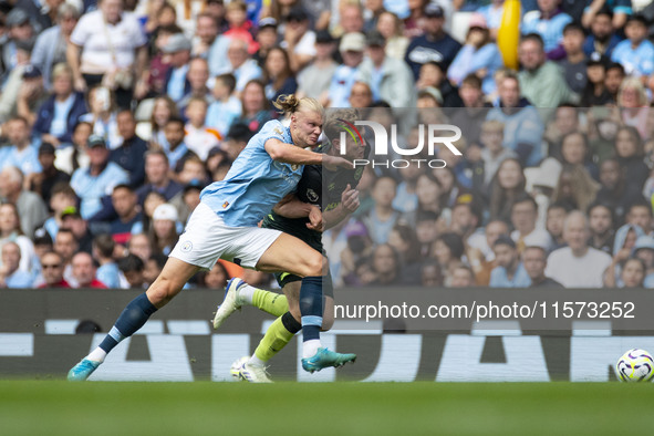 Nathan Collins #22 of Brentford F.C. is tackled by Erling Haaland #9 of Manchester City F.C. during the Premier League match between Manches...