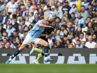 Nathan Collins #22 of Brentford F.C. is tackled by Erling Haaland #9 of Manchester City F.C. during the Premier League match between Manches...