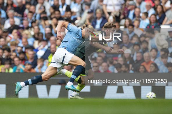 Nathan Collins #22 of Brentford F.C. is tackled by Erling Haaland #9 of Manchester City F.C. during the Premier League match between Manches...