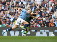 Nathan Collins #22 of Brentford F.C. is tackled by Erling Haaland #9 of Manchester City F.C. during the Premier League match between Manches...