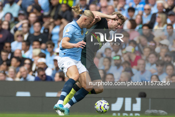 Nathan Collins #22 of Brentford F.C. is tackled by Erling Haaland #9 of Manchester City F.C. during the Premier League match between Manches...