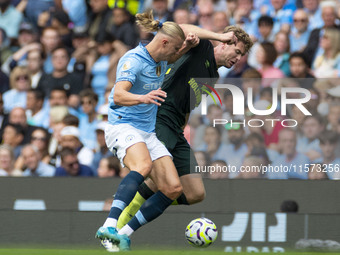 Nathan Collins #22 of Brentford F.C. is tackled by Erling Haaland #9 of Manchester City F.C. during the Premier League match between Manches...