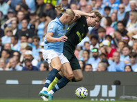 Nathan Collins #22 of Brentford F.C. is tackled by Erling Haaland #9 of Manchester City F.C. during the Premier League match between Manches...