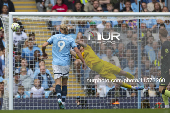 Mark Fleckken #1 (GK) of Brentford F.C. makes a save during the Premier League match between Manchester City and Brentford at the Etihad Sta...