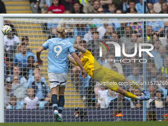 Mark Fleckken #1 (GK) of Brentford F.C. makes a save during the Premier League match between Manchester City and Brentford at the Etihad Sta...