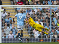 Mark Fleckken #1 (GK) of Brentford F.C. makes a save during the Premier League match between Manchester City and Brentford at the Etihad Sta...