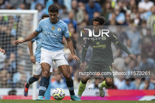 Rodri #16 of Manchester City F.C. is in possession of the ball during the Premier League match between Manchester City and Brentford at the...