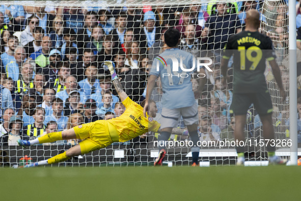 Mark Fleckken #1 (GK) of Brentford F.C. makes a save during the Premier League match between Manchester City and Brentford at the Etihad Sta...