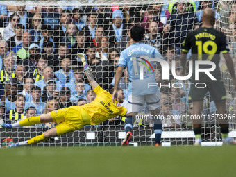 Mark Fleckken #1 (GK) of Brentford F.C. makes a save during the Premier League match between Manchester City and Brentford at the Etihad Sta...