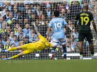 Mark Fleckken #1 (GK) of Brentford F.C. makes a save during the Premier League match between Manchester City and Brentford at the Etihad Sta...