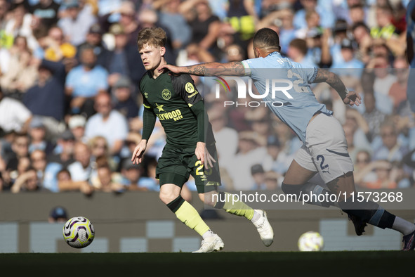 Kyle Walker #2 of Manchester City F.C. tackles the opponent during the Premier League match between Manchester City and Brentford at the Eti...