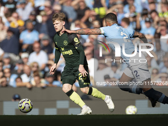 Kyle Walker #2 of Manchester City F.C. tackles the opponent during the Premier League match between Manchester City and Brentford at the Eti...