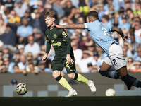 Kyle Walker #2 of Manchester City F.C. tackles the opponent during the Premier League match between Manchester City and Brentford at the Eti...